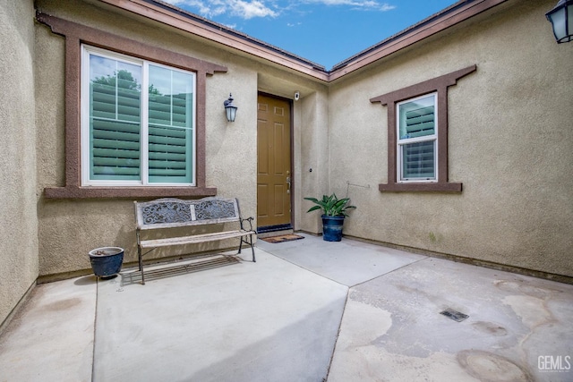 18019 Lapis Ln, San Bernardino, CA 92407 - view of exterior entry with a patio area and stucco siding