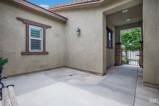 18019 Lapis Ln, San Bernardino, CA 92407 - doorway to property featuring stucco siding and a patio area