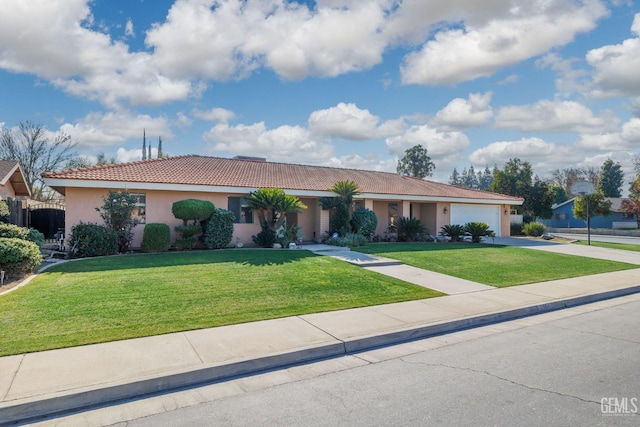 ranch-style home featuring a front yard and a garage