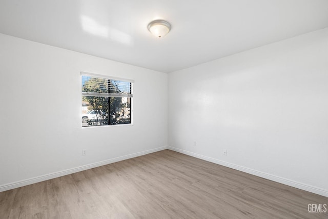 unfurnished room with light wood-type flooring