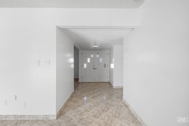 hallway featuring a textured ceiling