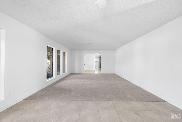 carpeted spare room with a textured ceiling