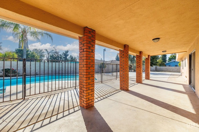 view of patio with a fenced in pool