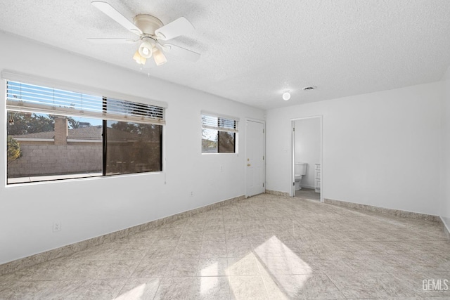 unfurnished room featuring ceiling fan and a textured ceiling