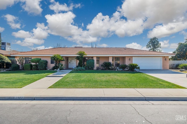 ranch-style house with a garage and a front lawn