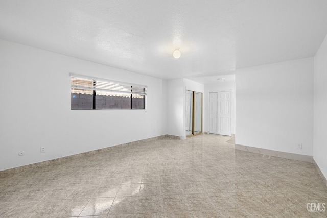 spare room featuring a textured ceiling