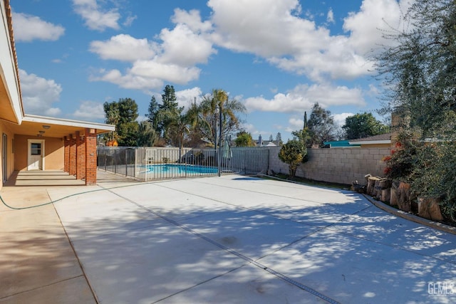 view of sport court featuring a fenced in pool and a patio area