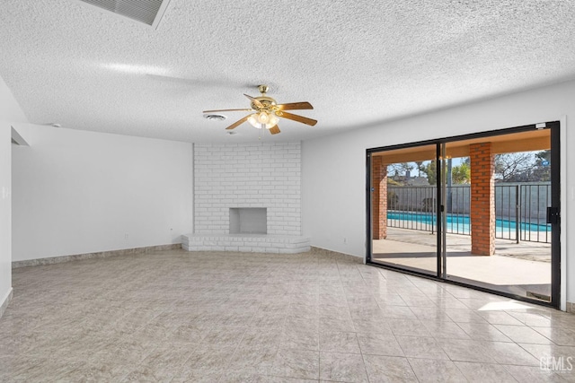 unfurnished living room with a fireplace, light tile patterned floors, a textured ceiling, and ceiling fan