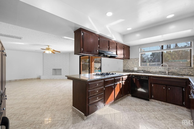 kitchen with dishwasher, sink, ceiling fan, a fireplace, and dark brown cabinets