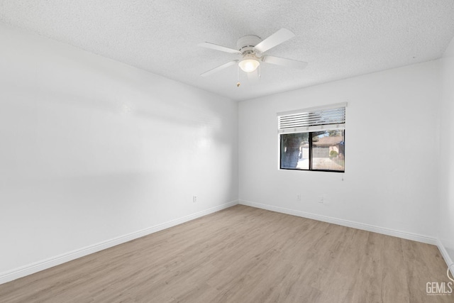 empty room featuring ceiling fan, a textured ceiling, and light wood-type flooring