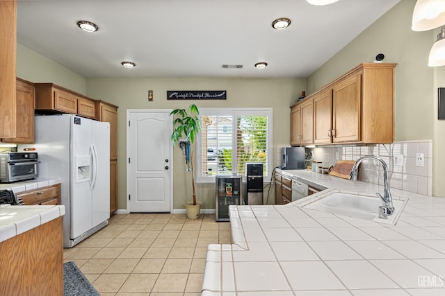 2109 Via Tuscania Ave, Delano, CA 93215 - kitchen featuring tile counters, a sink, dishwasher, beverage cooler, and white fridge with ice dispenser