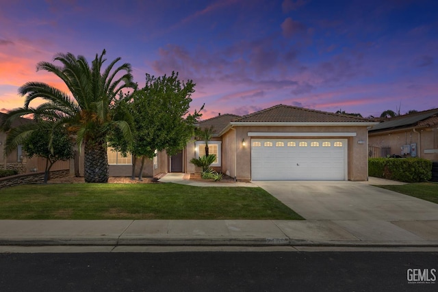 2109 Via Tuscania Ave, Delano, CA 93215 - ranch-style house with a tile roof, a garage, driveway, a front yard, and stucco siding
