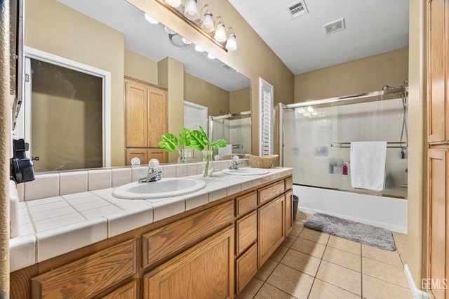 2109 Via Tuscania Ave, Delano, CA 93215 - bathroom with double vanity, tile patterned floors, and bath / shower combo with glass door