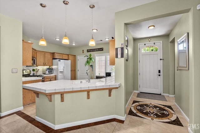 2109 Via Tuscania Ave, Delano, CA 93215 - kitchen featuring appliances with stainless steel finishes, tile counters, and inlaid floor details