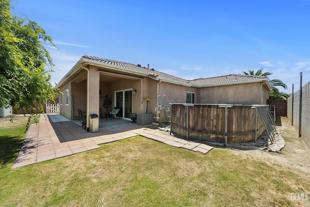2109 Via Tuscania Ave, Delano, CA 93215 - rear view of property with stucco siding, a tiled roof, and a patio