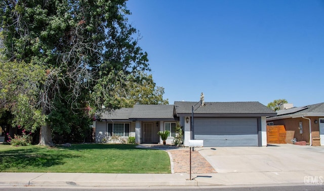 ranch-style home featuring a garage and a front lawn