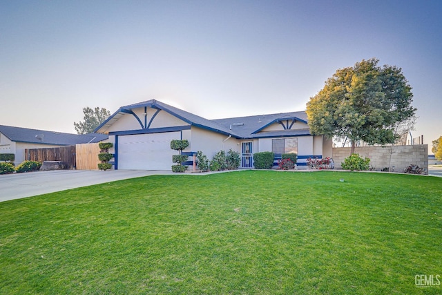 view of front of property with a yard and a garage