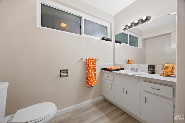 bathroom featuring vanity, toilet, and wood-type flooring