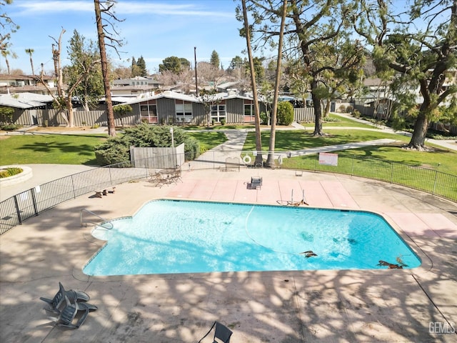 view of swimming pool featuring a lawn and a patio area