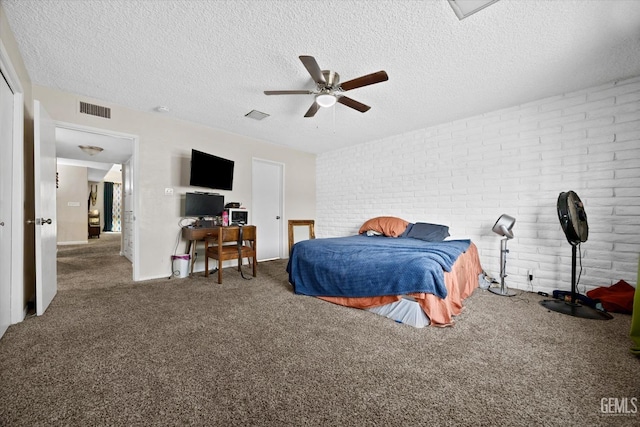 carpeted bedroom featuring ceiling fan, brick wall, and a textured ceiling