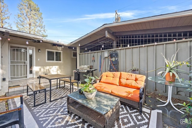 view of patio with area for grilling and an outdoor hangout area