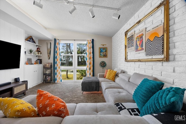 carpeted living room with vaulted ceiling, a textured ceiling, and brick wall