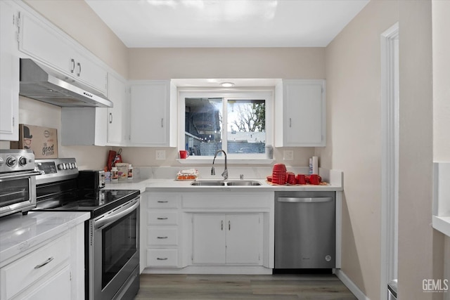 kitchen featuring white cabinetry, sink, hardwood / wood-style flooring, and appliances with stainless steel finishes