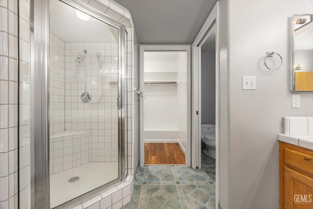 3625 Bernard St Unit 5, Bakersfield, CA 93306 - bathroom featuring a stall shower, vanity, and toilet