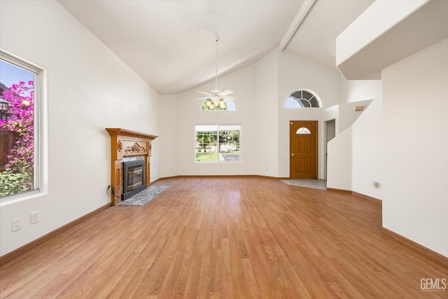 3625 Bernard St Unit 5, Bakersfield, CA 93306 - unfurnished living room with light wood finished floors, ceiling fan, beamed ceiling, a fireplace with flush hearth, and high vaulted ceiling