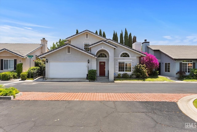 3625 Bernard St Unit 5, Bakersfield, CA 93306 - view of front of home featuring a garage, stucco siding, a chimney, and driveway