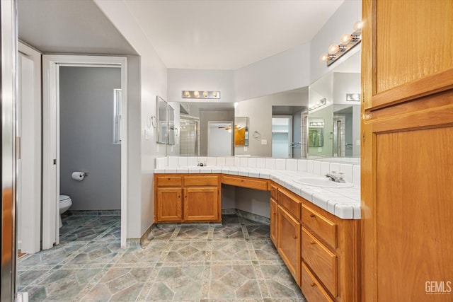 3625 Bernard St Unit 5, Bakersfield, CA 93306 - bathroom with double vanity, toilet, a shower stall, and stone finish flooring