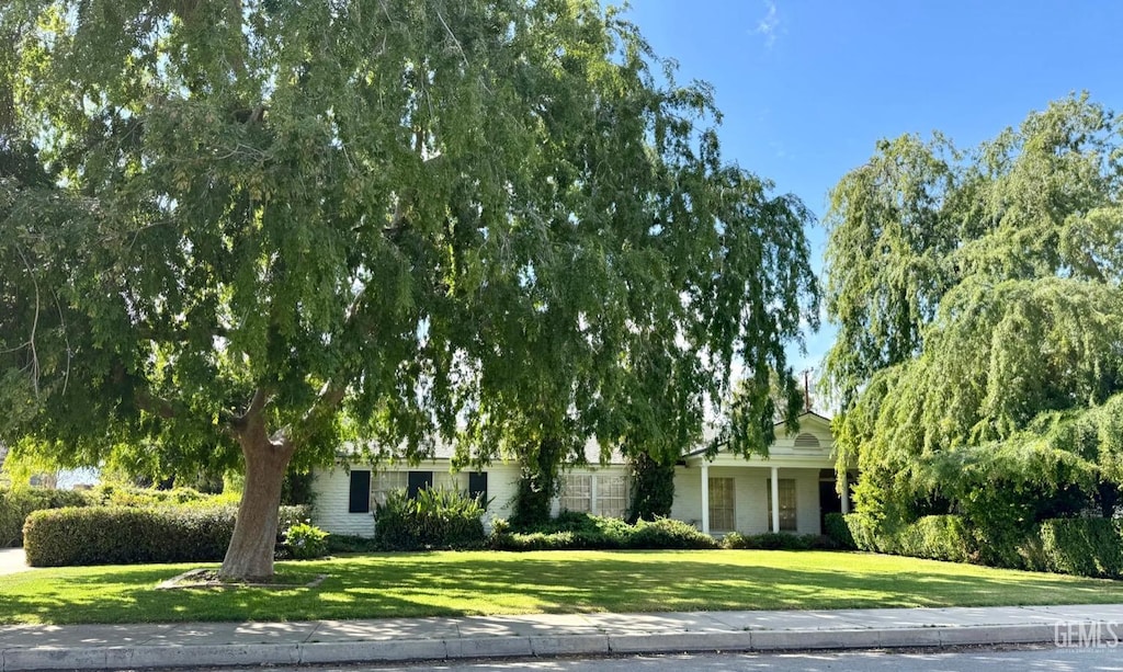 719 Mannel Ave, Shafter, CA 93263 - obstructed view of property with a front lawn