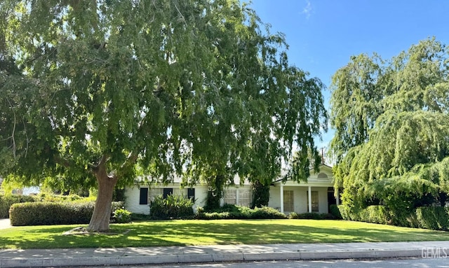 719 Mannel Ave, Shafter, CA 93263 - obstructed view of property with a front lawn