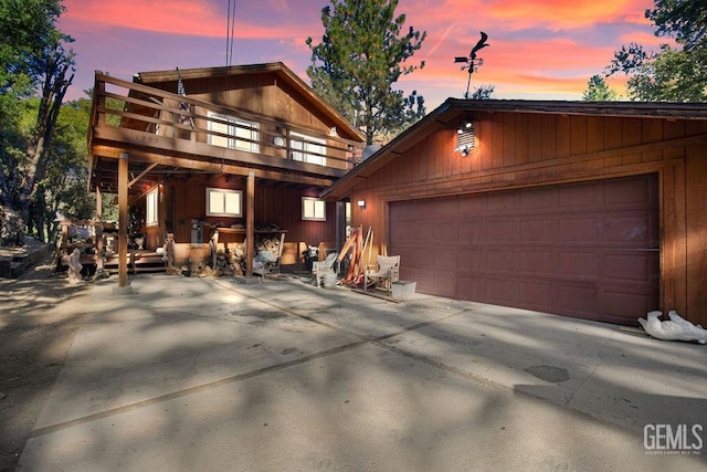 view of front of house with a wooden deck, an outbuilding, and a garage