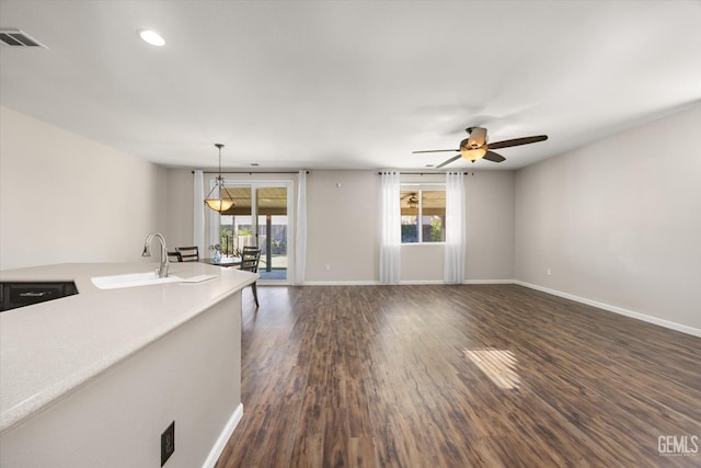 11313 Valletta Ave, Bakersfield, CA 93312 - unfurnished living room with healthy amount of natural light, a ceiling fan, dark wood-type flooring, and recessed lighting