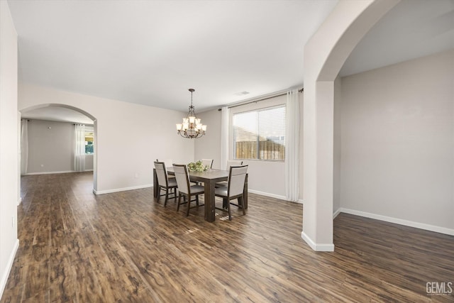 11313 Valletta Ave, Bakersfield, CA 93312 - dining space featuring plenty of natural light, dark wood-type flooring, a chandelier, and arched walkways