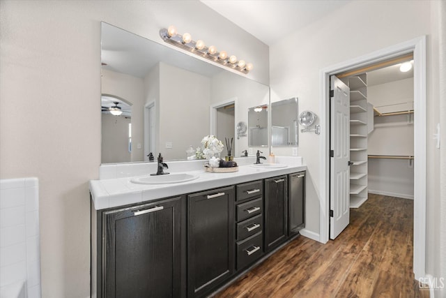 11313 Valletta Ave, Bakersfield, CA 93312 - full bathroom featuring double vanity, wood finished floors, a walk in closet, and a ceiling fan