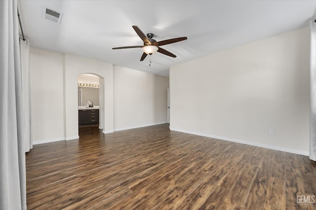 11313 Valletta Ave, Bakersfield, CA 93312 - spare room featuring arched walkways, ceiling fan, and dark wood-style flooring
