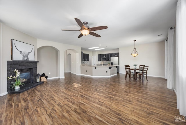 11313 Valletta Ave, Bakersfield, CA 93312 - living area with a ceiling fan, dark wood-style flooring, and a fireplace