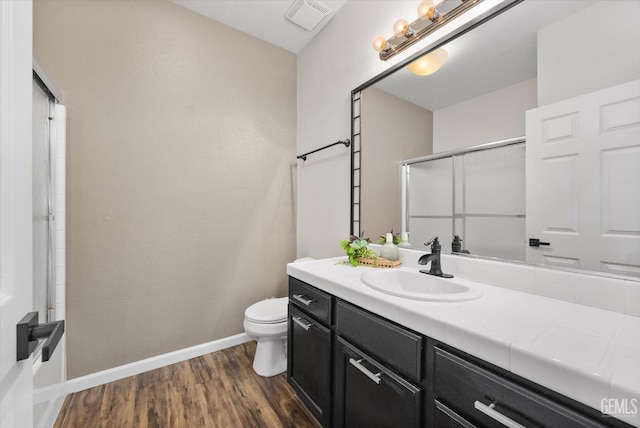 11313 Valletta Ave, Bakersfield, CA 93312 - full bath with vanity, wood finished floors, and a shower with shower door