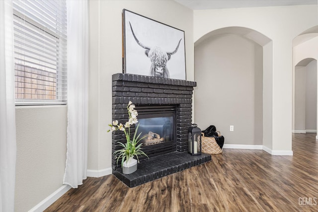 11313 Valletta Ave, Bakersfield, CA 93312 - detailed view of a brick fireplace, wood finished floors, and arched walkways