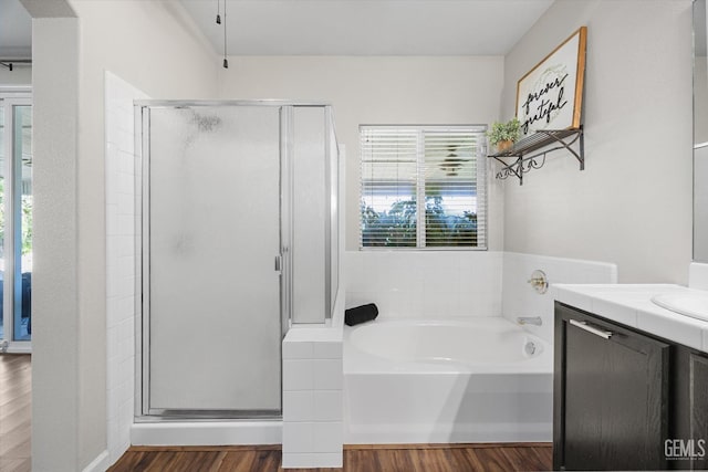 11313 Valletta Ave, Bakersfield, CA 93312 - bathroom featuring a shower stall, vanity, a bath, and wood finished floors