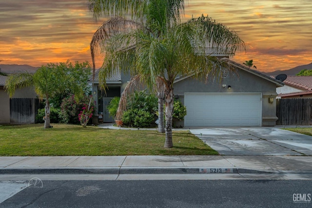 5213 San Martin Dr, Bakersfield, CA 93307 - view of front of property with a garage, stucco siding, and concrete driveway