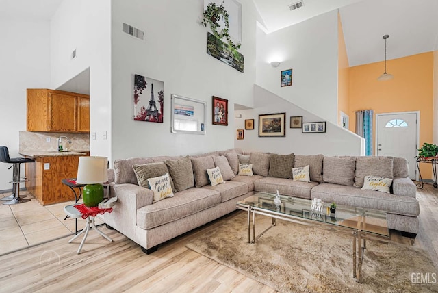 5213 San Martin Dr, Bakersfield, CA 93307 - living room featuring a towering ceiling and light wood-style floors