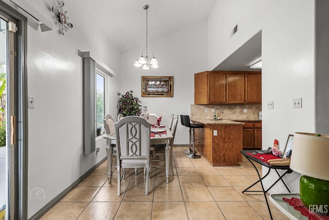 5213 San Martin Dr, Bakersfield, CA 93307 - dining room with a chandelier, light tile patterned floors, and high vaulted ceiling