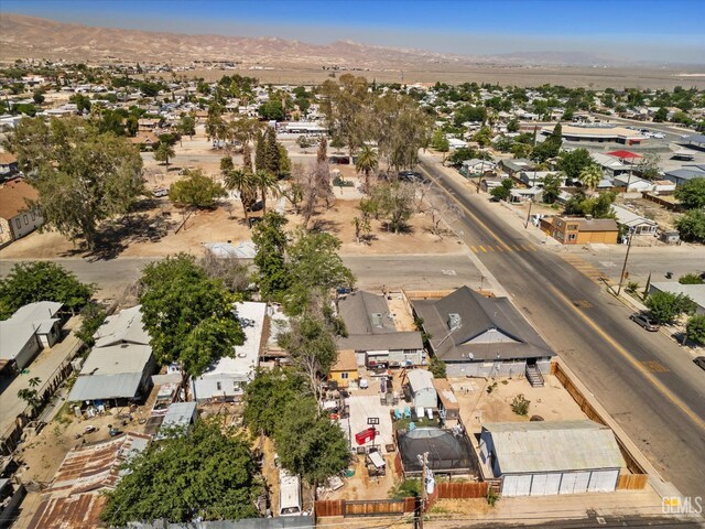 220 Tyler St, Taft, CA 93268 - aerial view of property and surrounding area featuring a mountain backdrop and nearby suburban area