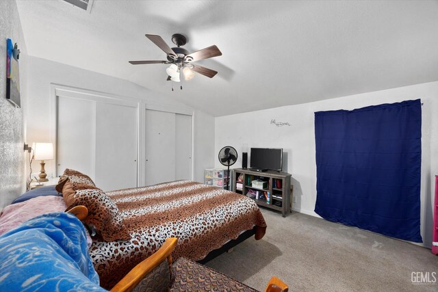220 Tyler St, Taft, CA 93268 - carpeted bedroom featuring vaulted ceiling, two closets, and ceiling fan