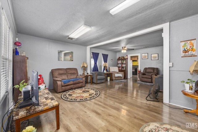 220 Tyler St, Taft, CA 93268 - living area with wood finished floors, a textured ceiling, and a ceiling fan