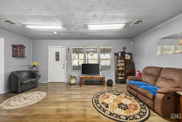 220 Tyler St, Taft, CA 93268 - living room featuring a textured ceiling, wood finished floors, and crown molding