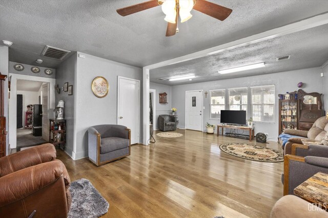 220 Tyler St, Taft, CA 93268 - living room with wood finished floors, a textured ceiling, and ceiling fan